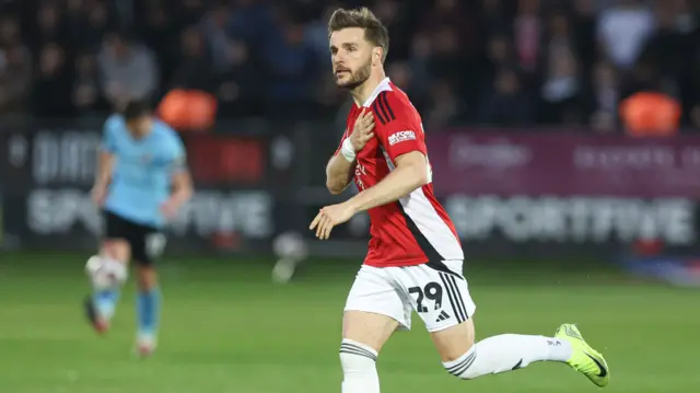 Luke Garbutt of Salford City celebrates scoring to make it 1-1