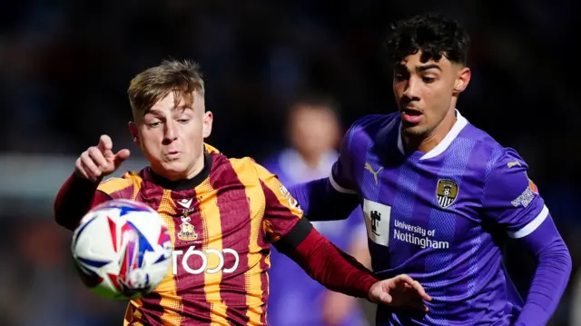Bradford's Bobby Pointon and Notts County's George Abbott battle for the ball