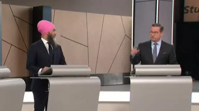 Two men speaking at podiums
