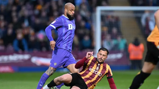 Notts County striker David McGoldrick is tackled by Bradford' Antoni Sarcevic