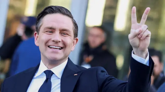 Poilievre smiling and throwing up a peace sign
