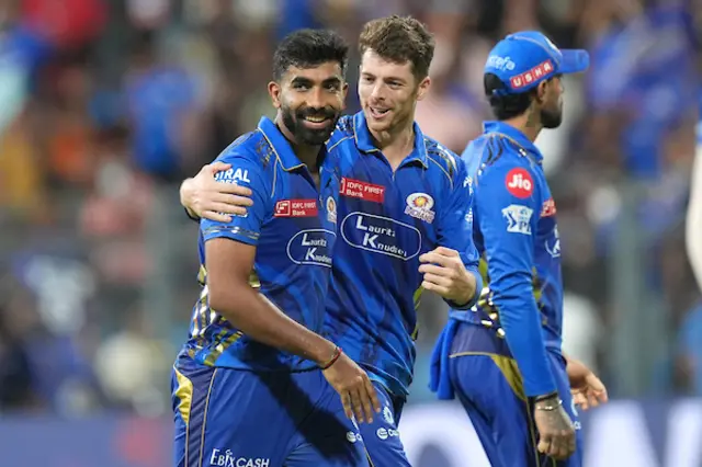 Jasprit Bumrah and Mitchell Santner celebrate a wicket for Mumbai Indians