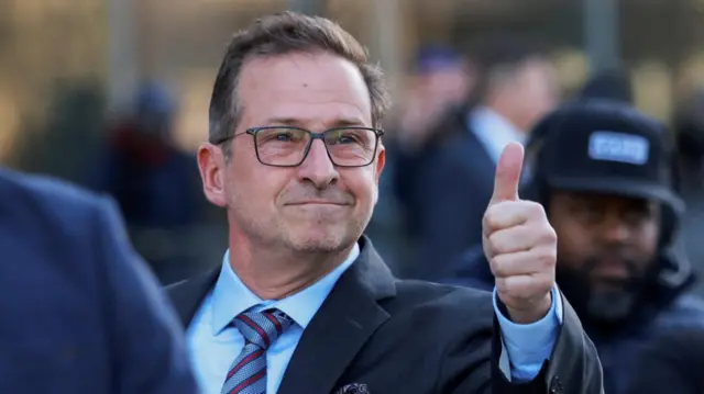 Blanchet smiling and holding a thumbs up