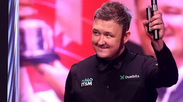 Kyren Wilson enters the Crucible Theatre