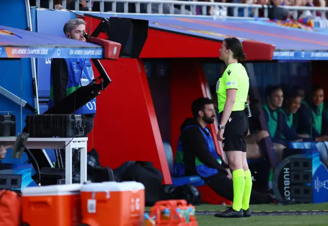 Ref checks the monitor after a handball