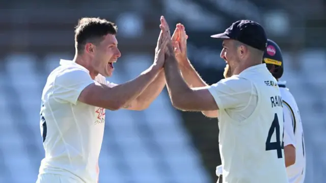 Matthew Potts and Ben Raine celebrate a Yorkshire wicket
