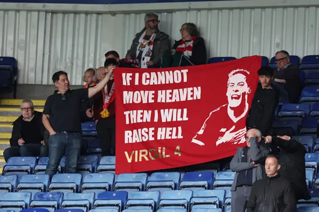 Liverpool fans hold a banner in support of Virgil van Dijk
