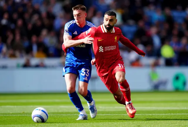 Leicester City's Luke Thomas and Liverpool's Mohamed Salah battle for the ball