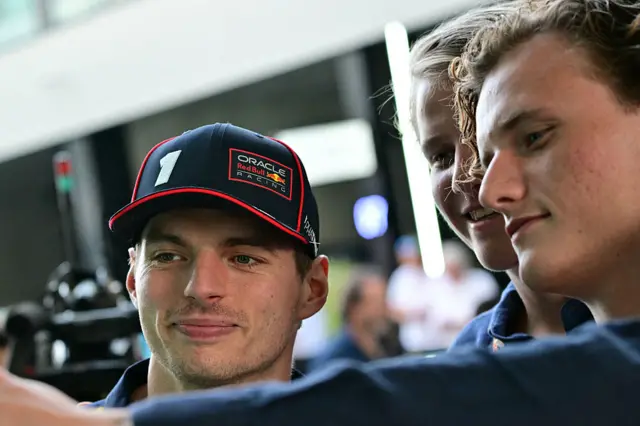 Max Verstappen takes a picture with a fan