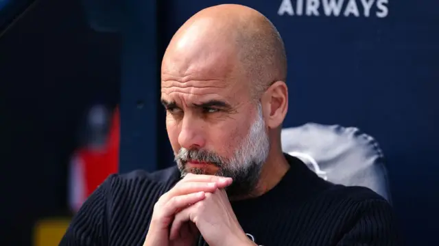 Pep Guardiola, Manager of Manchester City, looks on