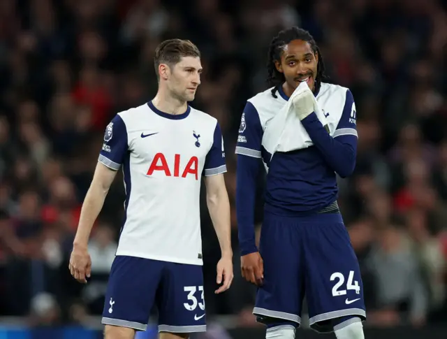 Davies and Spence chat during a stoppage in play