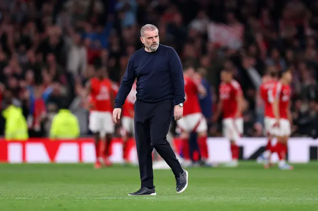 Postecoglou walks across the pitch as Forest players celebrate in the background