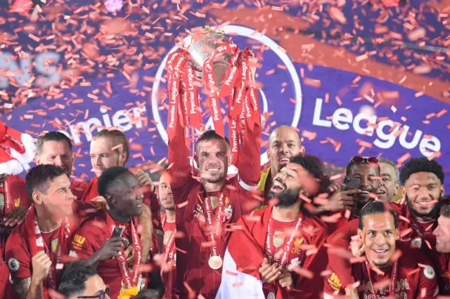 Jordan Henderson lifts the Premier League trophy