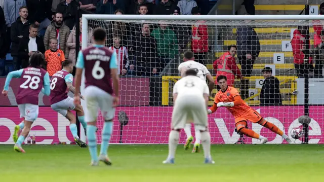 Josh Brownhill scores his penalty past Michael Cooper