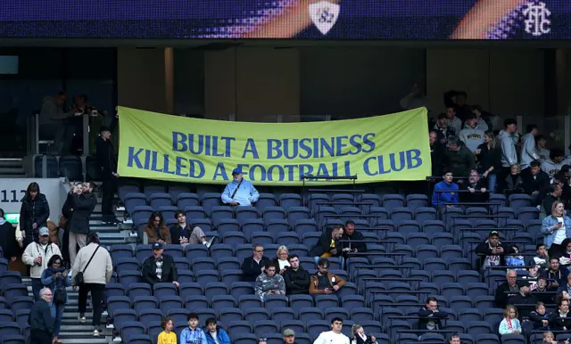 Tottenham fan banner in the stands reads: Built a business killed a football club