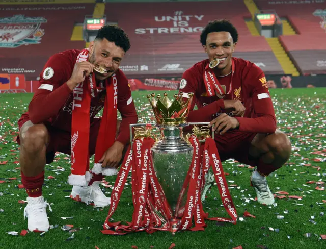 Alex Oxlade-Chamberlain and Trent Alexander-Arnold with the Premier League trophy