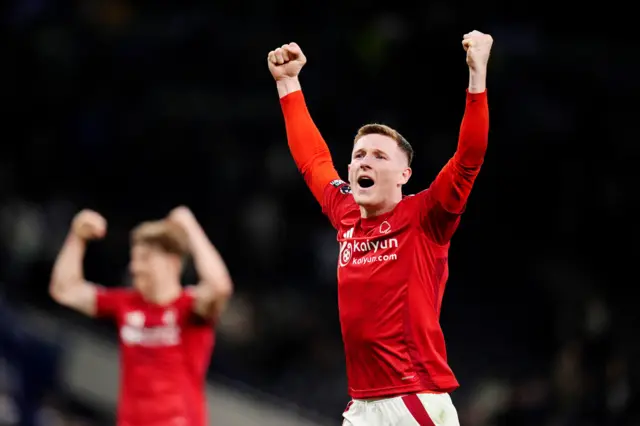 Forest players celebrate their win in front of the away end
