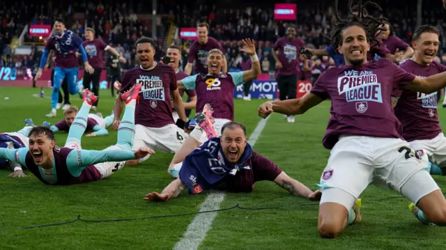 Burnley players celebrate wearing "We Are Premier League" t-shirts