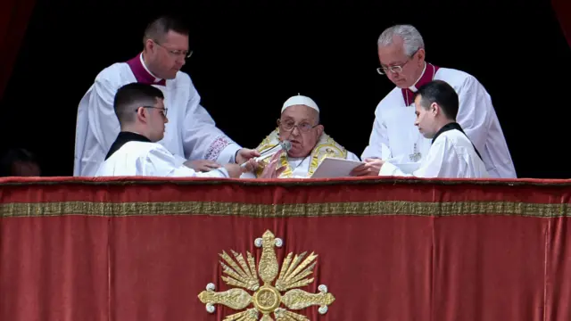Pope Francis speaks from a balcony