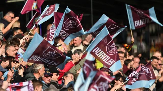 Burnley fans wave flags and banners at Turf Moor