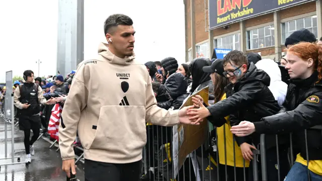 Joel Piroe greets fans as he arrives at Elland Road