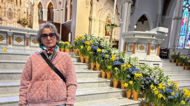 Beata stands near the altar of the Cathedral of the Holy Cross in Boston