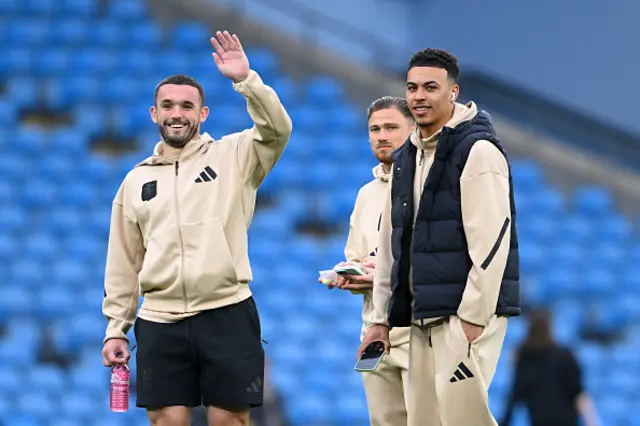 John McGinn, Matty Cash and Morgan Rogers of Aston Villa inspect the pitch