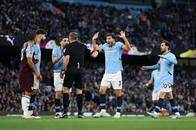 Ruben Dias of Manchester City reacts towards Referee Craig Pawson