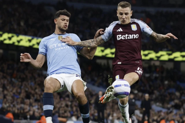 Aston Villa's Lucas Digne in action with Manchester City's Matheus Nunes