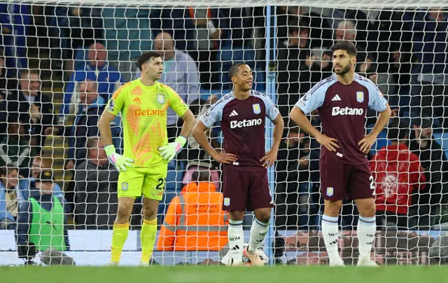 Aston Villa's Emiliano Martinez Youri Tielemans and Marco Asensio react