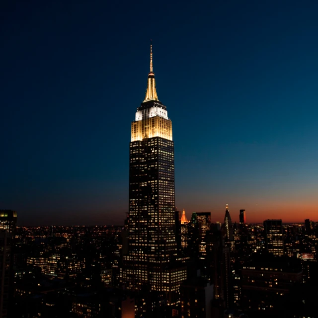 The Empire State Building in New York lit in gold and white to commemorate the death of Pope Francis