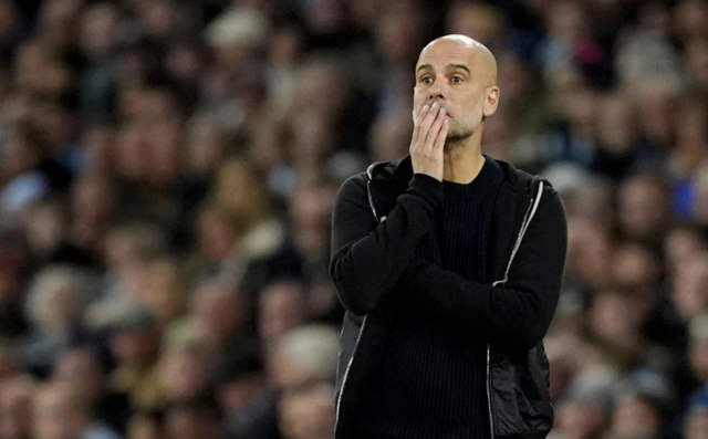 Manchester City manager Pep Guardiola looks on