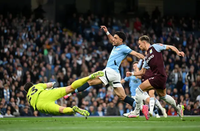 Omar Marmoush of Manchester City has a shot saved by Emiliano Martinez