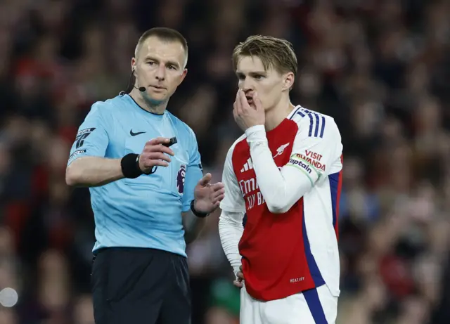 Referee and Martin Odegaard discussing VAR