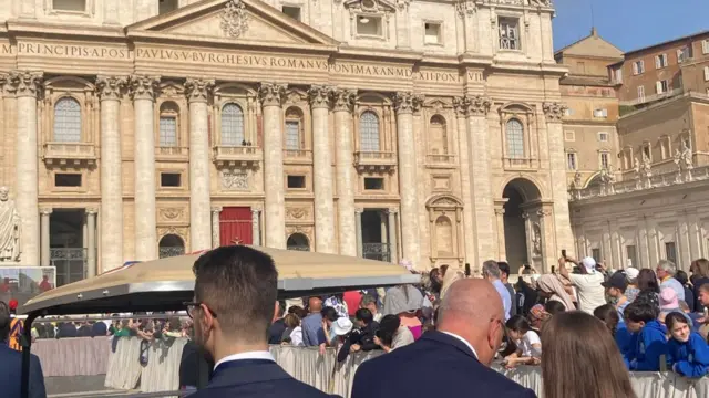 Front of St Peter's Basilica in Vatican City as Pope's coffin approaches, worshippers stand in front