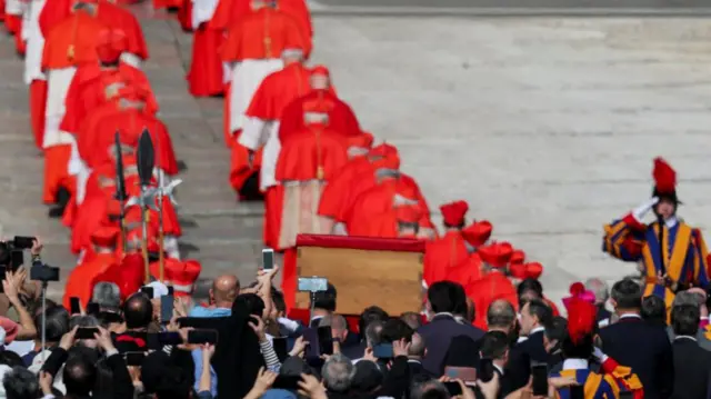 Shot from behind showing procession entering the basilica