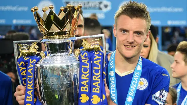 Jamie Vardy of Leicester City poses for photographs wit the Premier League Trophy