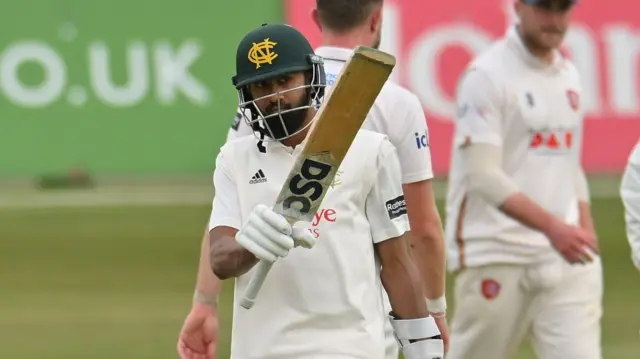 Nottinghamshire batter Haseeb Hameed waves his bat to the dressing room after reaching 50