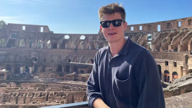 Joe Mitchell wears a black shirt and sunglasses.