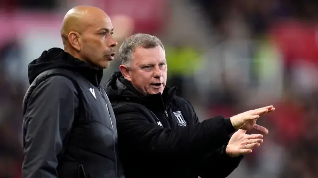Mark Robins (right) and assistant Paul Nevin on the touchline for Stoke