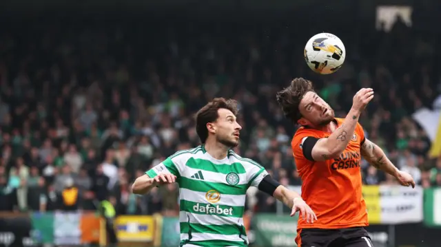 Dundee utd's Will Ferry and Celtic's Nicolas Kuhn in action during a William Hill Premiership match between Dundee Utd and Celtic at the CalForth Construction Arena