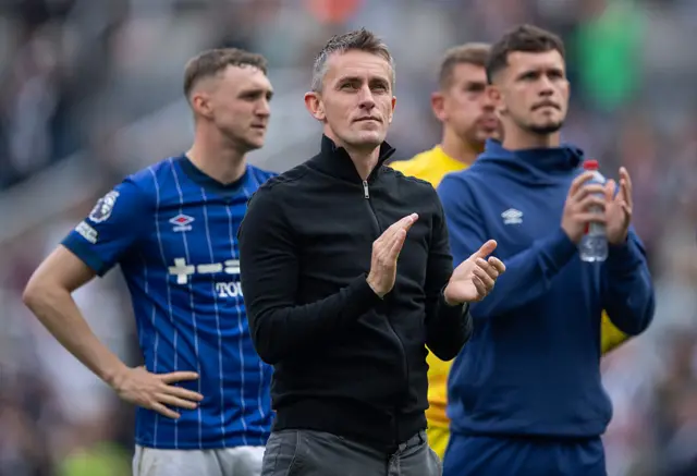 McKenna and his players clap the away fans at full time
