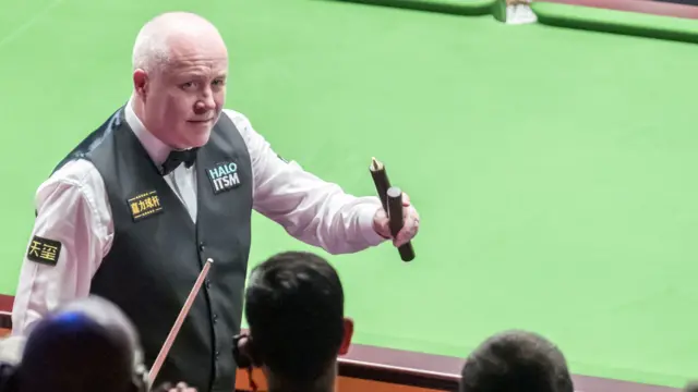 John Higgins celebrates