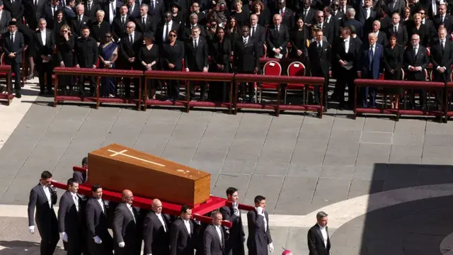 Picture of leaders on front row as coffin brought in