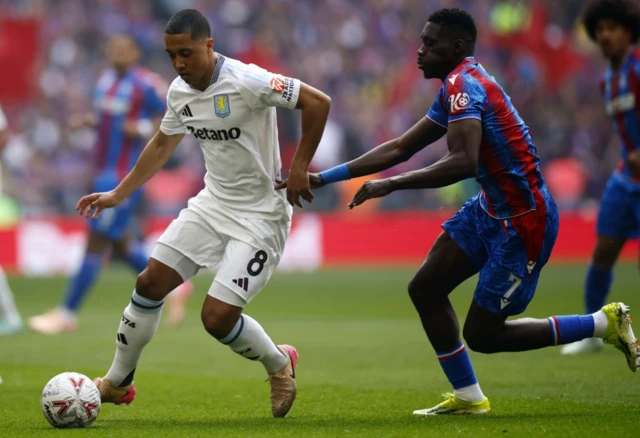 Aston Villa's Lucas Digne (R) and Crystal Palace's Jean-Philippe Mateta in action