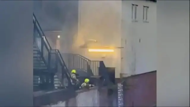 Firefighters tackle a fire at Luton's Kenilworth Road ground