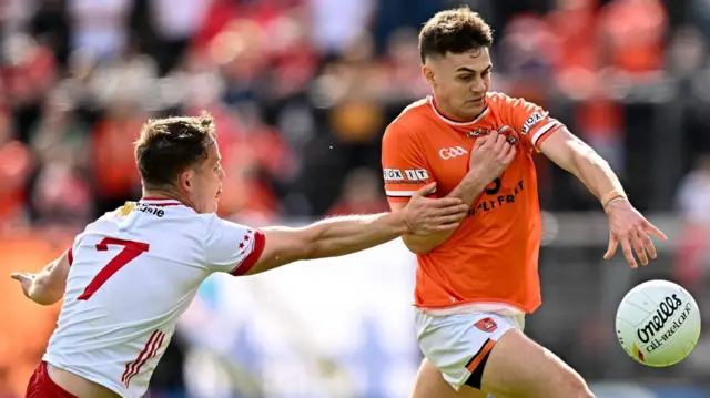 Tyrone's Kieran McGeary challenges Armagh's Darragh McMullen