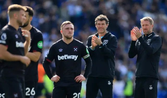 West Ha m players and manager clap the travelling fans at full time