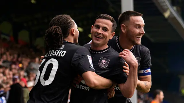 Josh Cullen (centre) is hugged by team-mates after scoring
