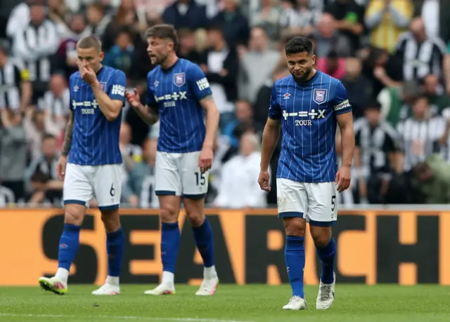 Ipswich players trudge back to kick off after conceding